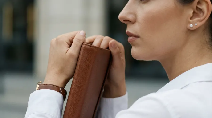 Minimalistyczna biżuteria i zegarek w damskiej stylizacji biznesowej